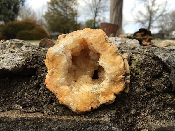Crystal quartz placed in a wooden flower bed.