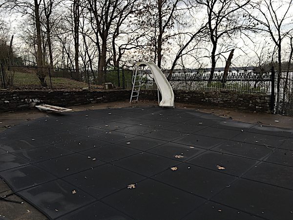 The still-covered swimming pool.