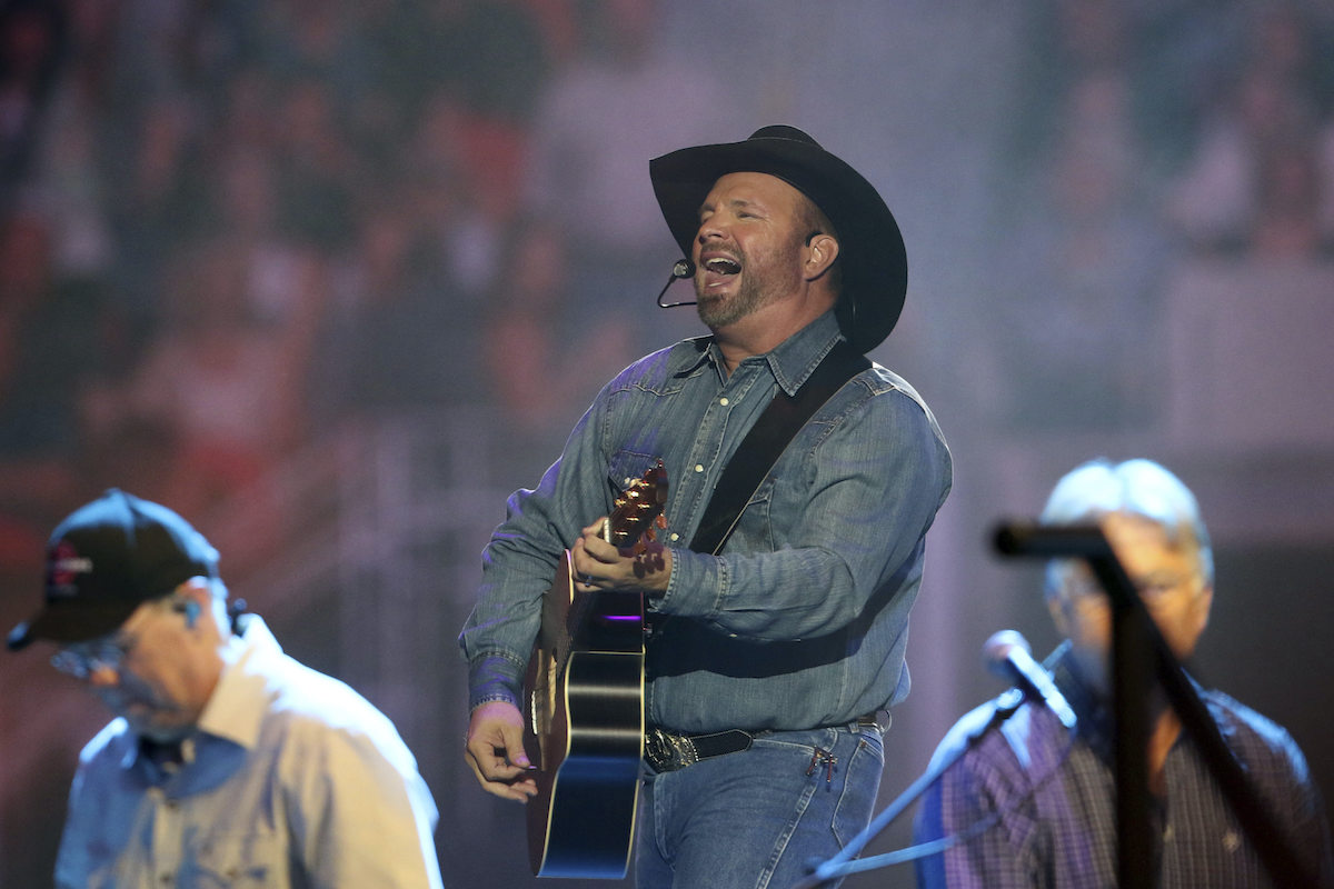 Garth Brooks performs to a packed stadium crowd.