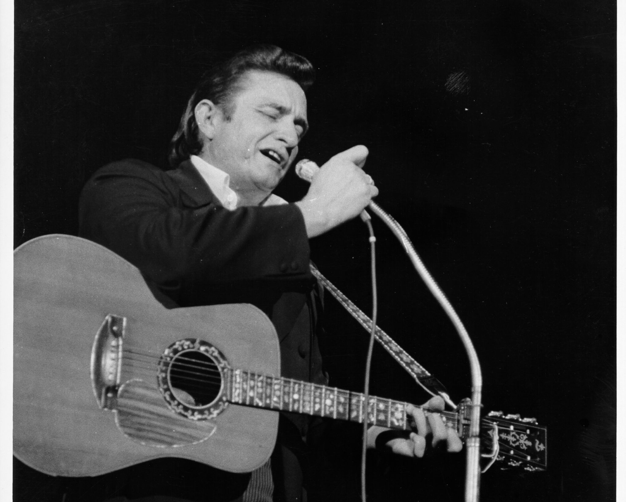 Country singer/songwriter Johnny Cash performs onstage in 1968 in Los Angeles, California.