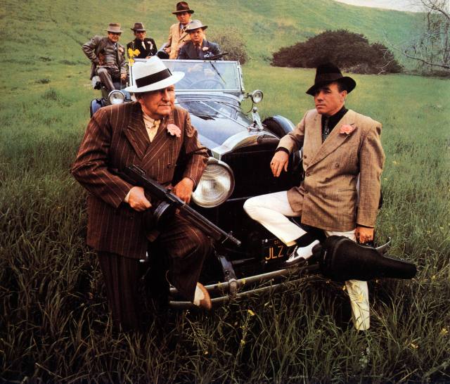 Photo of Earl Scruggs and Lester Flatt posed in a field