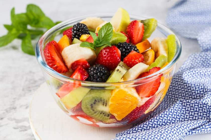 Delicious fruit salad on a plate on table.