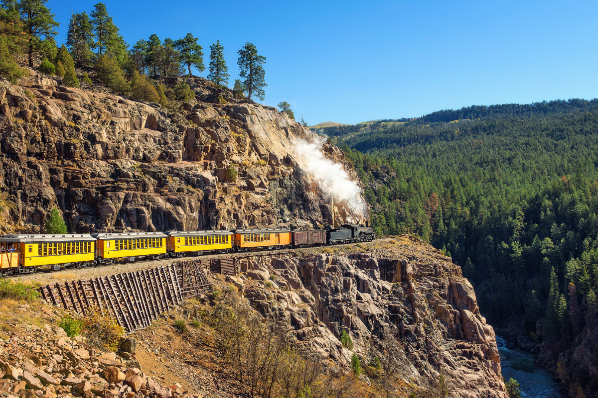 Historic steam engine train travels from Durango to Silverton through the San Juan Mountains in Colorado, USA.