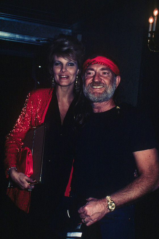 Willie Nelson with his wife Connie Keopke. She is wearing a red sequined jacket; circa 1970; New York.