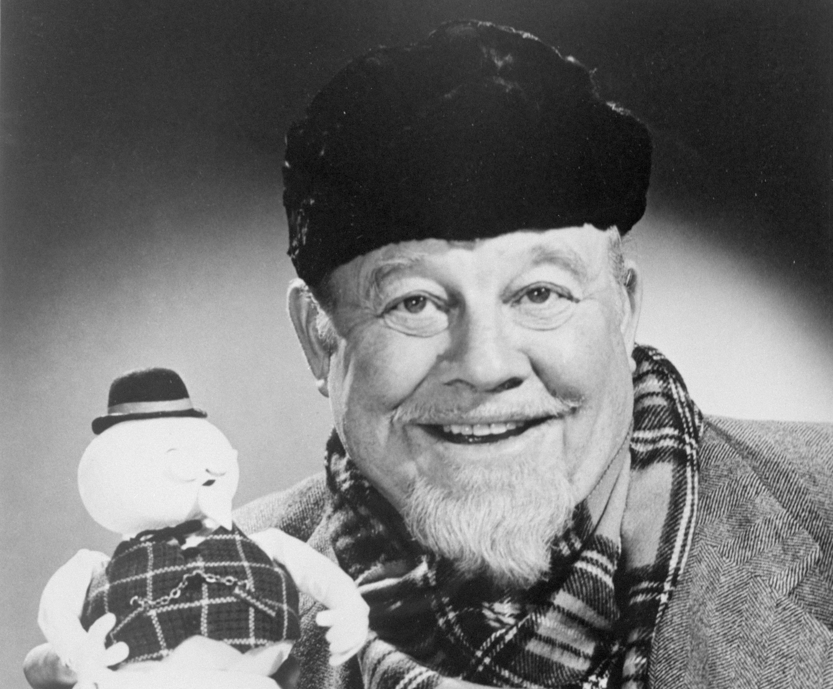 Burl Ives holds up the stop-motion snowman puppet of Sam, whose voice he provides in the TV Christmas special, "Rudolph the Red-Nosed Reindeer".