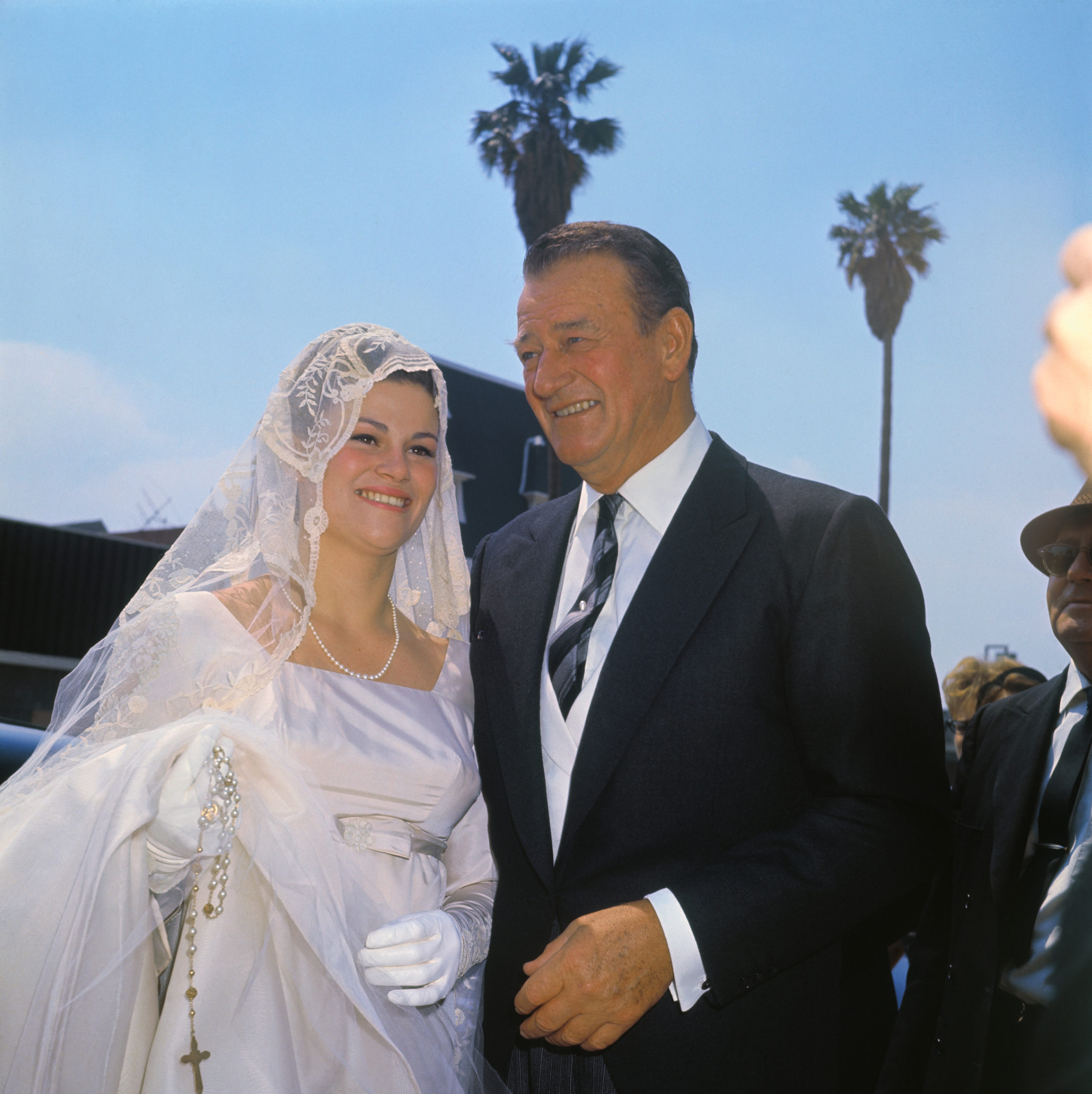 ohn Wayne with his daughter Melinda Ann on her wedding day. Her new husband is Gregory Robert Munoz.