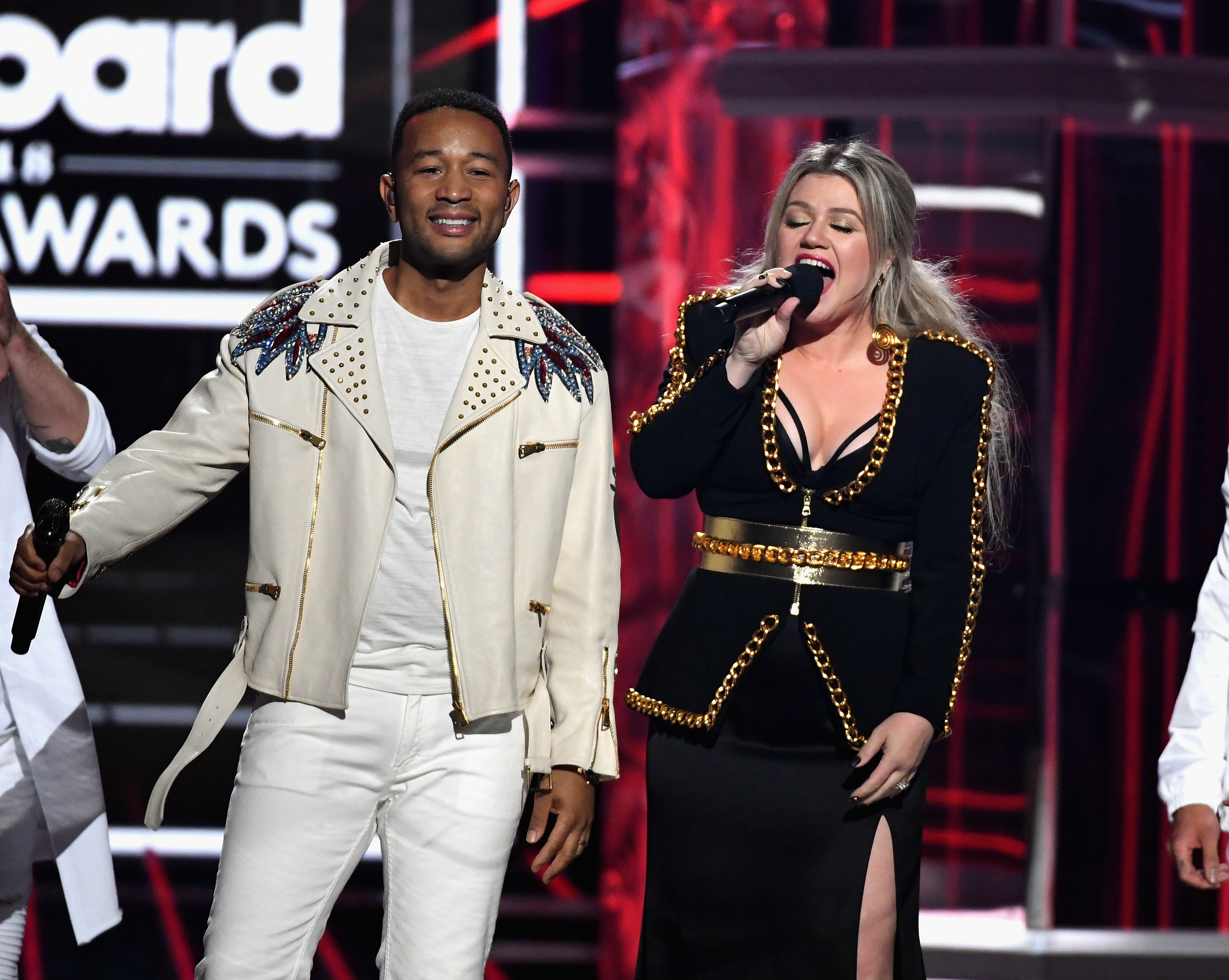 LAS VEGAS, NV - MAY 20: Recording artists John Legend and Kelly Clarkson speak onstage during the 2018 Billboard Music Awards at MGM Grand Garden Arena on May 20, 2018 in Las Vegas, Nevada. 