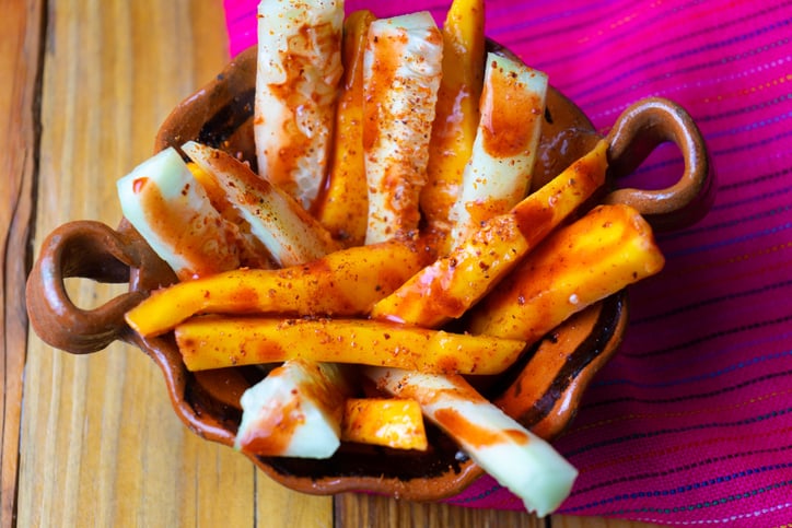 Cucumber and mangoes with chili powder and chamoy. Mexican dessert