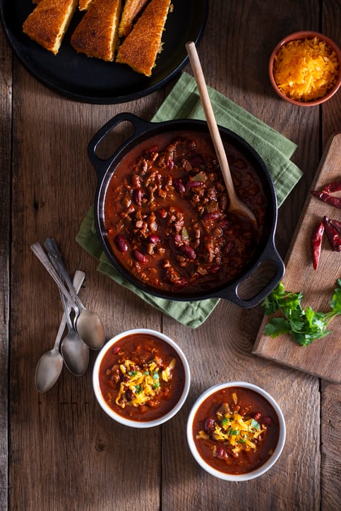 Bowls of Homemade Chili with Corn Bread, Cilantro and Cheddar Cheese