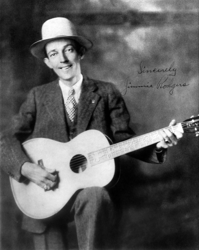 Photo of Country singer Jimmie Rodgers (1897-1933) posed with acoustic guitar circa 1930.
