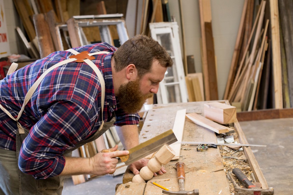 Ben Napier, star of HGTV's "Home Town," demonstrates hand-mortising a table leg at Scotsman Co. woodshop, in Laurel, MS. HGTV, one of the nation's top five, creates relatable starsthe Property Brothers, Chip and Joanna Gaines and is always looking for more. The cable giant's latest hit is "Home Town," starring Erin and Ben Napier, who were discovered on Instagram. The show, which co-stars the couple's tiny town of Laurel, MS, was selected from hundreds of possible programs. The show, now filmed the second season, promises to remake Laurel "one house at a time." 