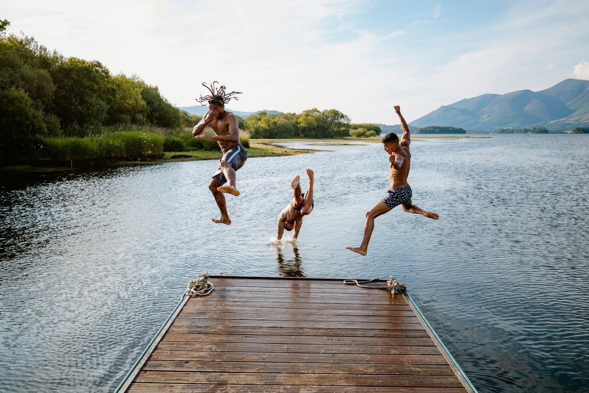 People at lake jumping in