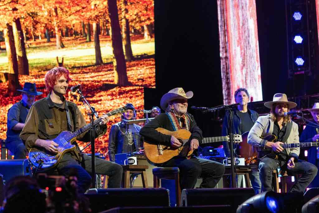 US musicians Micah Nelson, Willie Nelson, and Lukas Nelson perform during the Farm Aid 2021 music festival at the Xfinity Theatre on September 25, 2021 in Hartford, Connecticut. (Photo by SUZANNE CORDEIRO / AFP)