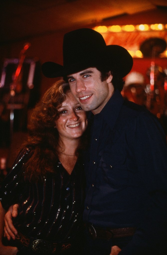 Actor John Travolta with Bonnie Raitt on set  during the Paramount Pictures movie  'Urban Cowboy" circa 1980. 
