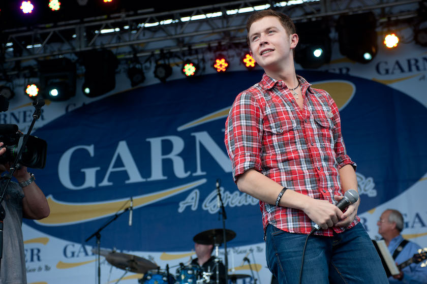 GARNER, NC - MAY 14: American Idol" finalist Scotty McCreery performs at an outdoor concert for adoring local fans at his homecoming celebration at Buffaloe Park May 14, 2011 in Garner, North Carolina. In the past six weeks, McCreery has gone from being a cashier at Lowes Foods and a singer known only around the Triangle to being a national if not global phenomenon on "American Idol." Residence and town officials prepared a hometown hero's welcome for McCreery two days after he advanced to become one of three top finalist in season ten of America Idol. 