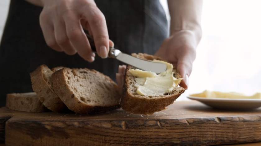 Spreading butter on bread