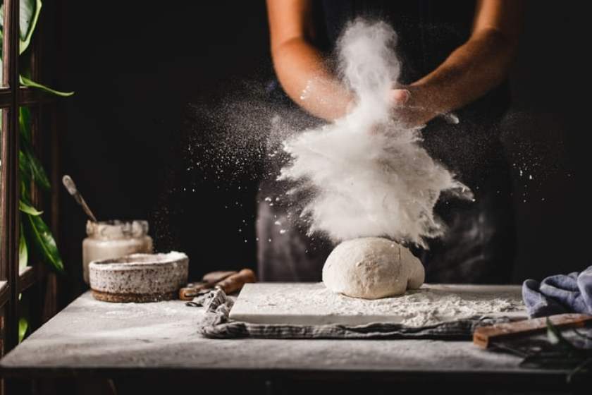  Female hands preparing sourdough bread in kitchen