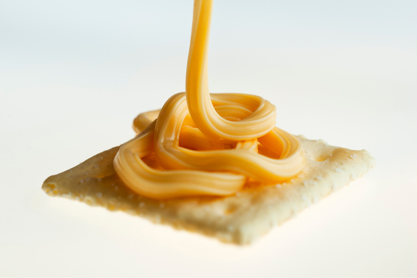 spray cheese on cracker