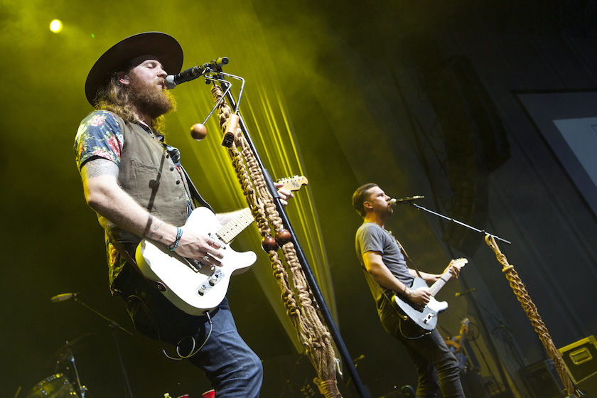 CHARLOTTE, NC - AUGUST 29:  Guitarist John Osborne (left) and singer/guitarist T.J. Osborne of Brothers Osborne perform at PNC Music Pavilion on August 29, 2015 in Charlotte, North Carolina.