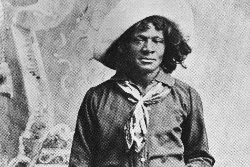 Nat Love, African American cowboy who claimed to have won the name of Deadwood Dick in South Dakota, 1876, by virtue of his roping talent. Full length photo with lariat and saddle. From his privately published autobiographyy (1907)