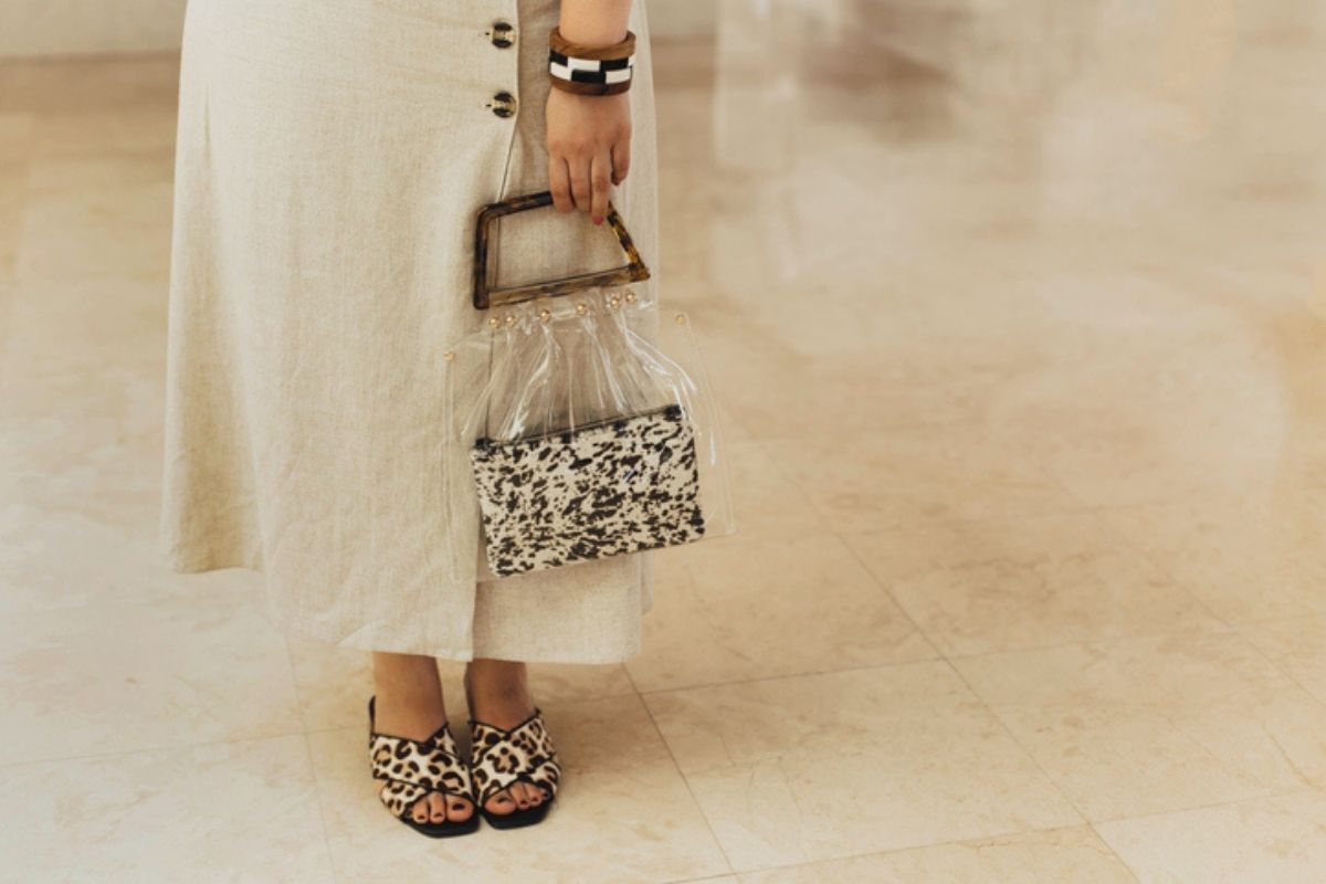 woman holding a clear purse