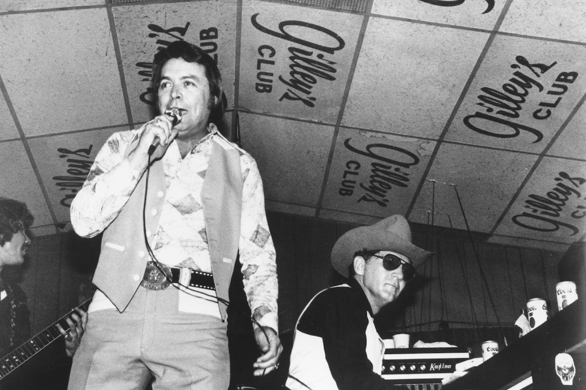 Singer and club owner Mickey Gilley performs with his cousin piano player Jerry Lee Lewis at Gilley's Club in Pasadena, Texas in circa 1975.