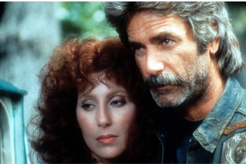 Cher leaning against Sam Elliott in a scene from the film 'Mask'