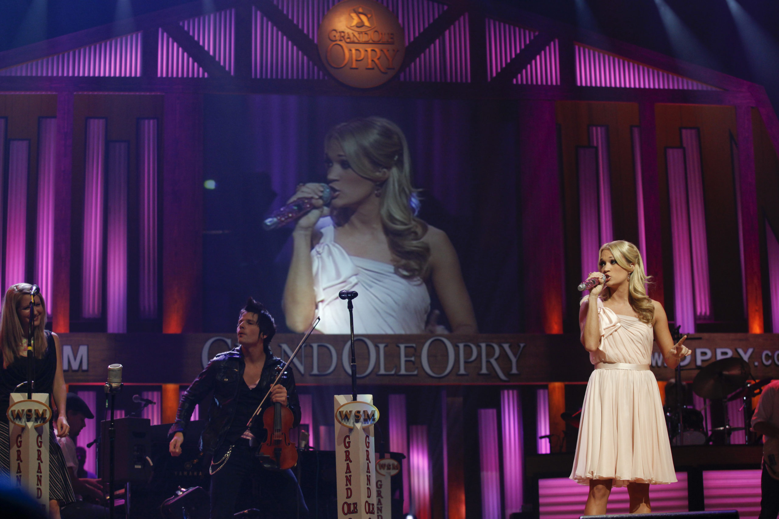 NASHVILLE, TN - OCTOBER 02: Carrie Underwood visits the Grand Ole Opry House to flip a switch to turn the backdrop pink to symbolize the fight against breast cancer on October 2, 2009 in Nashville, Tennessee. 