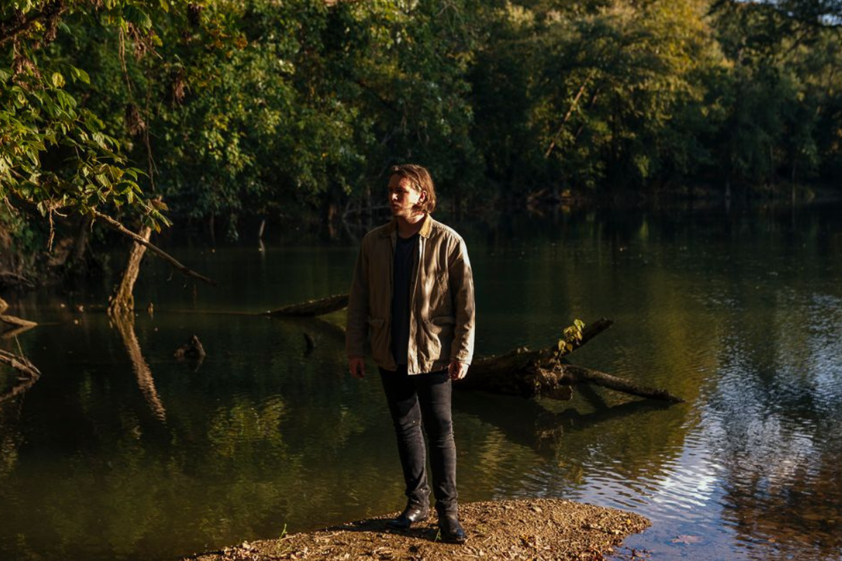 Ian Noe stands near river