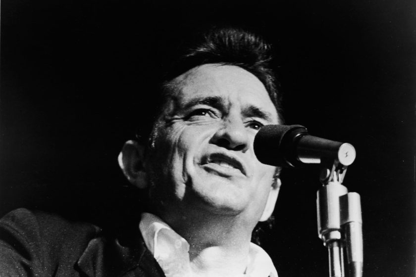 Headshot of American country singer Johnny Cash (1932 - 2003) singing on stage in a still from the film, 'Johnny Cash - The Man, His World, His Music,' directed by Robert Elfstrom, 1969.