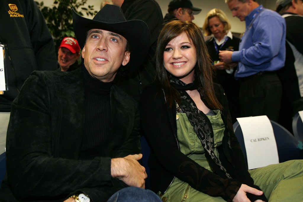 Actor Nicolas Cage poses with singer Kelly Clarkson prior to the NASCAR Nextel Cup Series Daytona 500 at Daytona International Speedway on February 18, 2007 in Daytona, Florida.