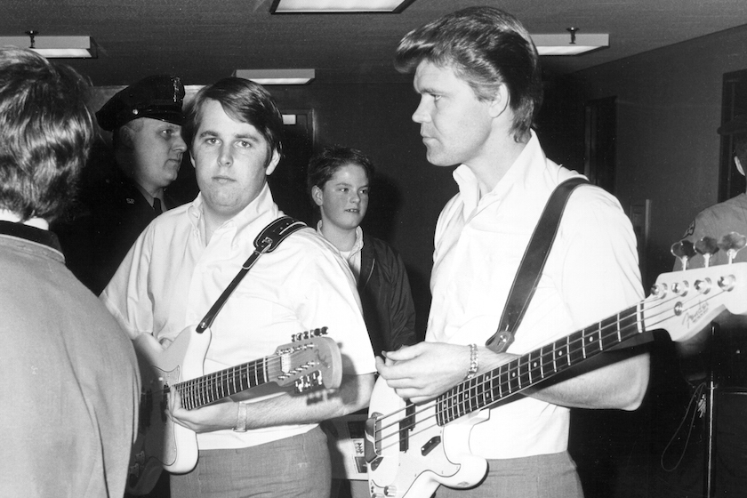 1965: Singer Glen Campbell and guitarist Carl Wilson of the rock and roll band "The Beach Boys" waiting backstage for a performance in 1965. Campbell replaced Brian Wilson as lead singer for performances in 1965.