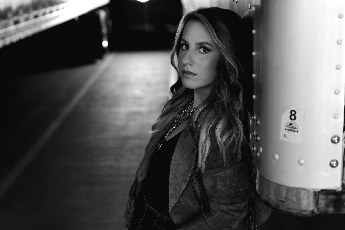 Caitlyn Smith leans against wall
