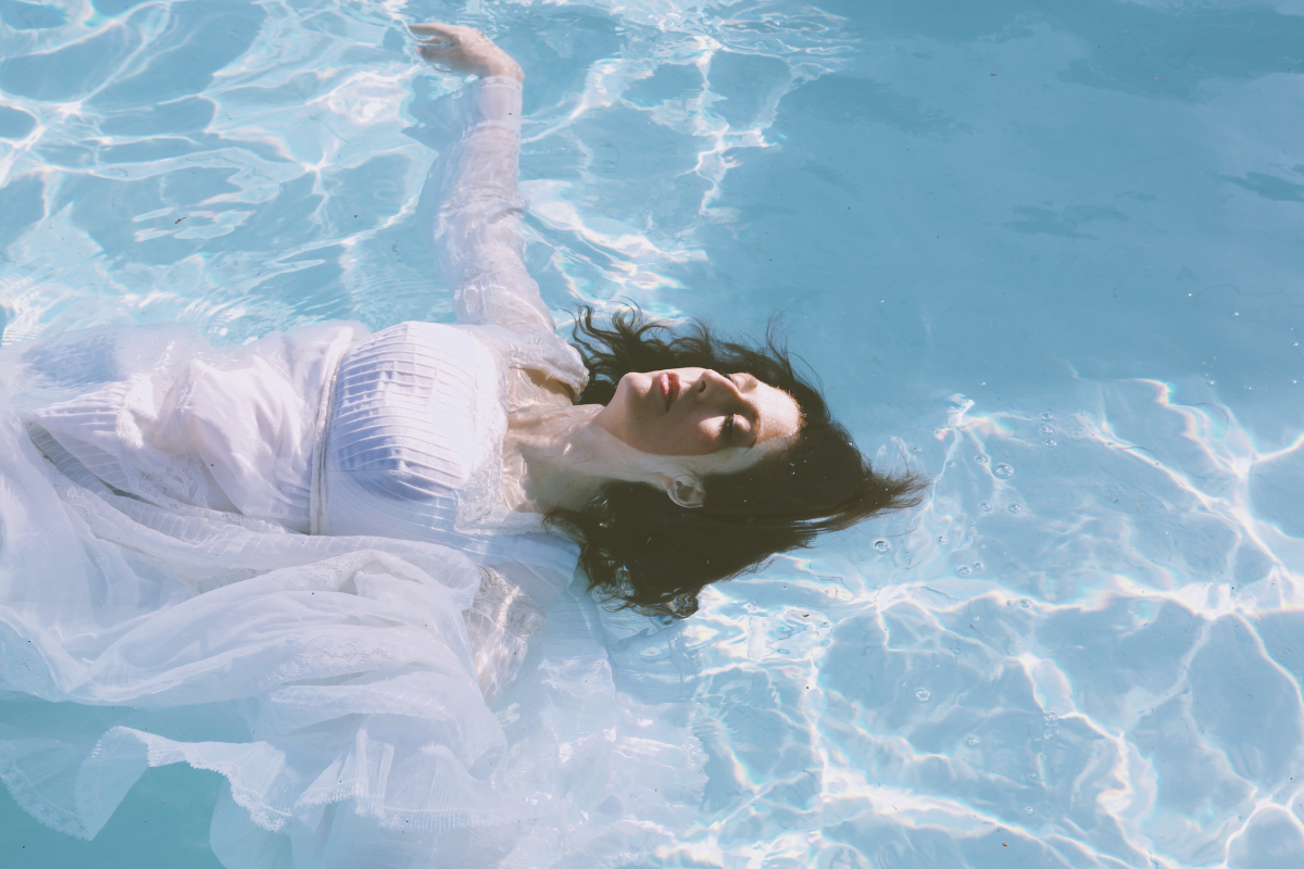 Ali Holder floats in water in press photo