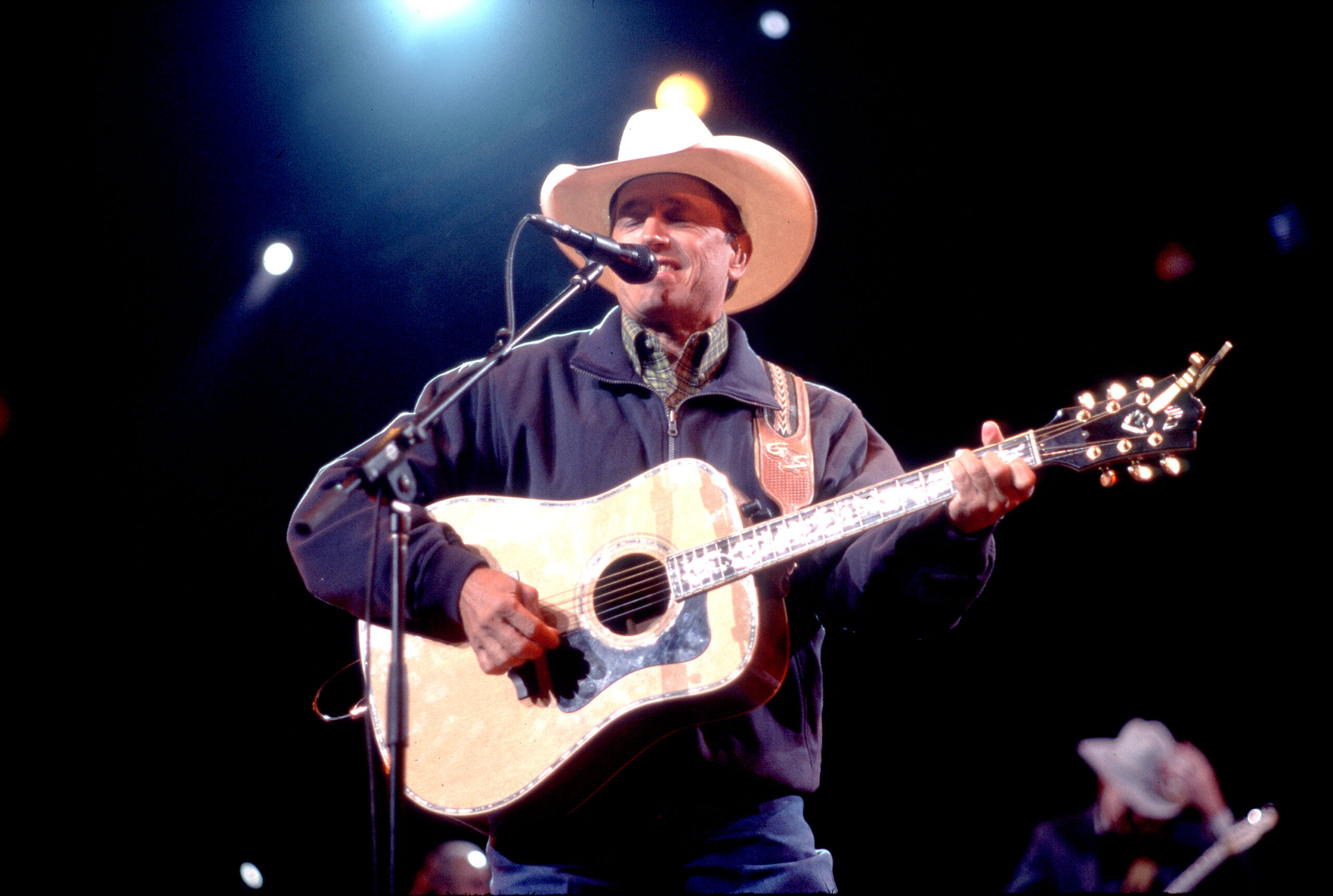 American Country musician George Strait plays guitar as he performs onstage at the Tweeter Center, Tinley Park, Illinois, May 5, 2001.