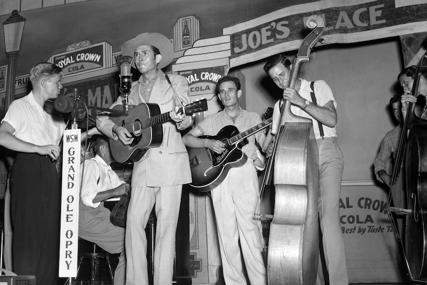 Country singer songwriter Hank Williams performs with the Drifting Cowboys (Jerry Rivers on Fiddle, Sammy Pruett on electric Guitar, Howard Watts on bass) on stage at the Grand Ole Opry in 1951 in Nashville, Tennessee. 