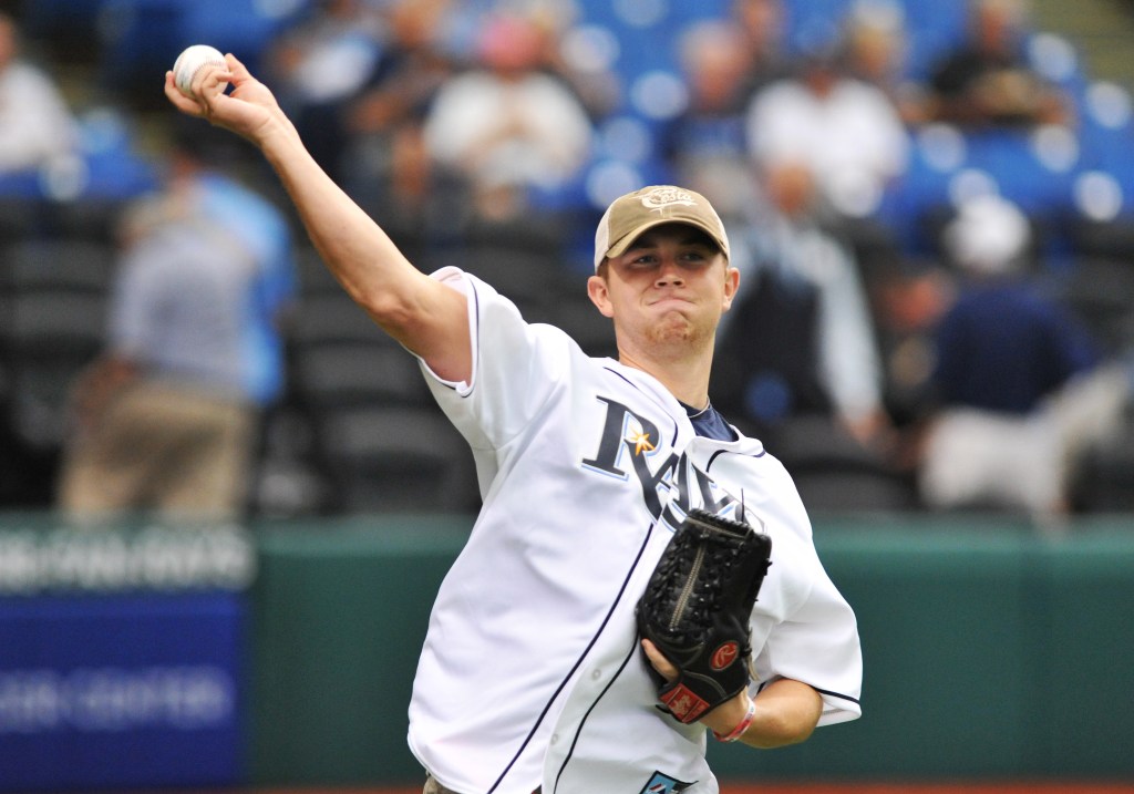 American Idol winner Scotty McCreery throws out a ceremonial 1st pitch before the Tampa Bay Rays play against the Los Angeles Angels of Anaheim August 29, 2013 at Tropicana Field in St. Petersburg, Florida.
