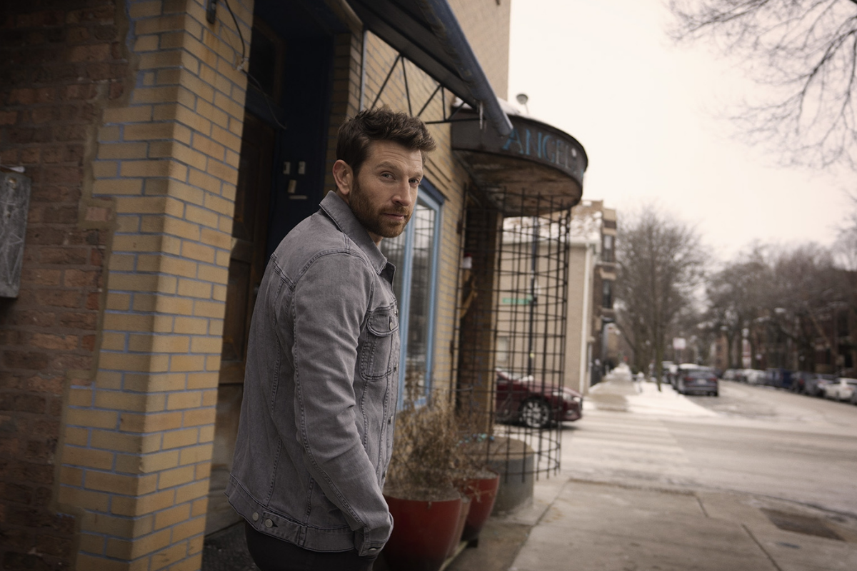 Brett Eldrege poses outside wearing denim jacket