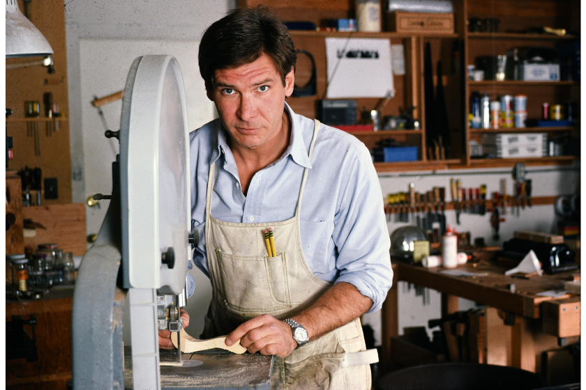 Harrison Ford is an American actor and film producer. He gained worldwide fame for his starring roles as Han Solo in the Star Wars film series and as the title character of the Indiana Jones film series. Photographed at home August 17 1984 , he was a keen woodworker and made tables and chairs for his home when he was married to his second wife, screenwriter Melissa Mathison, whom he married in March 1983 and lived in Mandeville Canyon, Beverly Hills, California