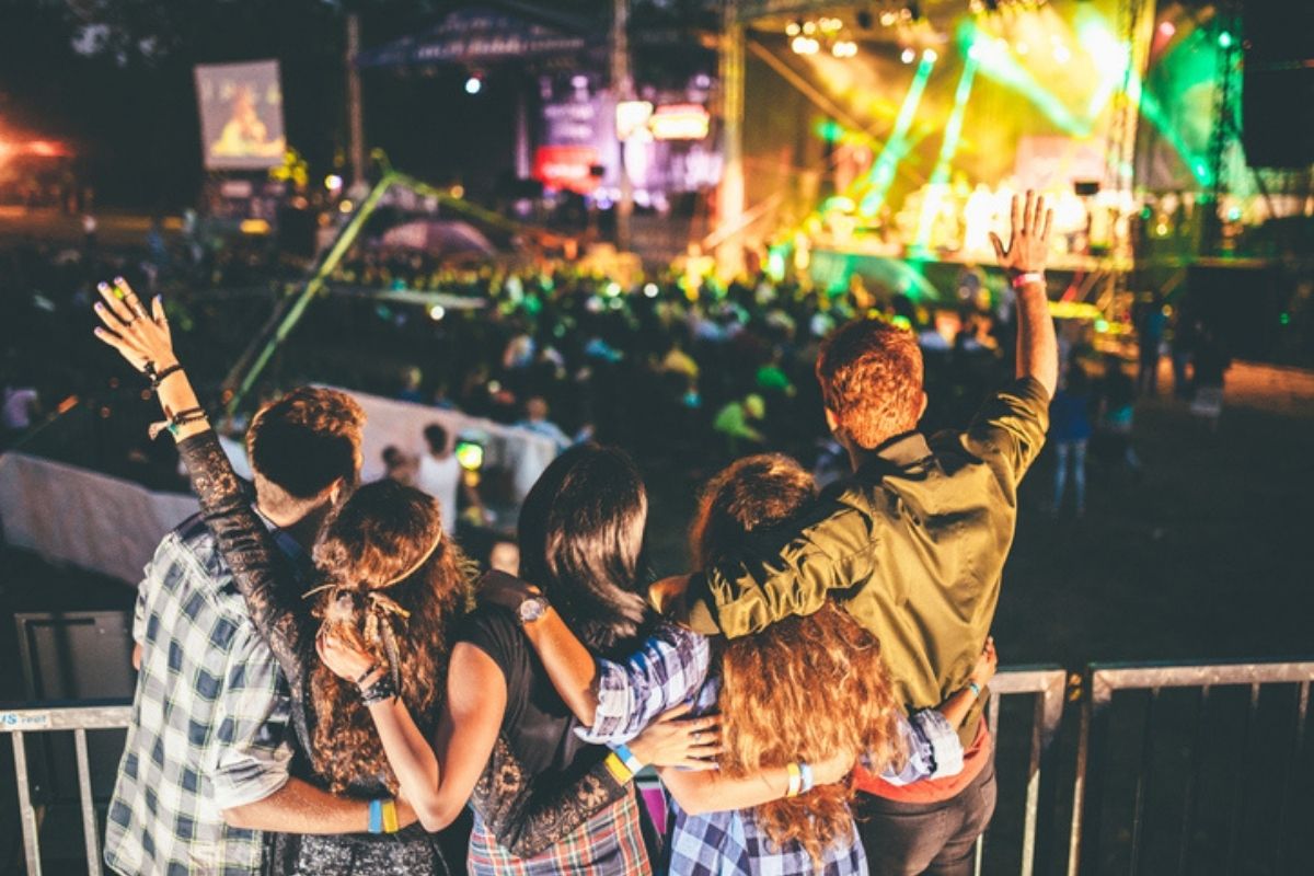 group of friends watching concert outside