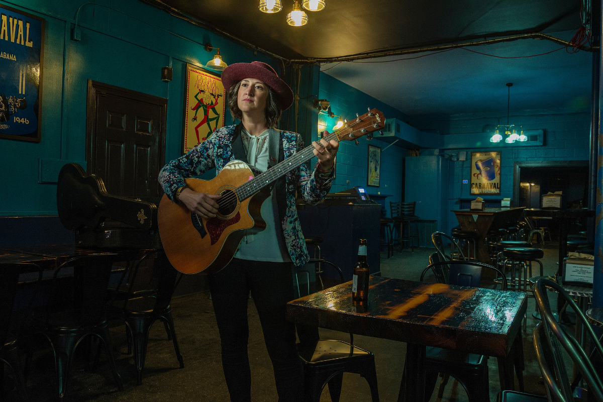 Ever More Nest's Kelcy Mae poses with guitar