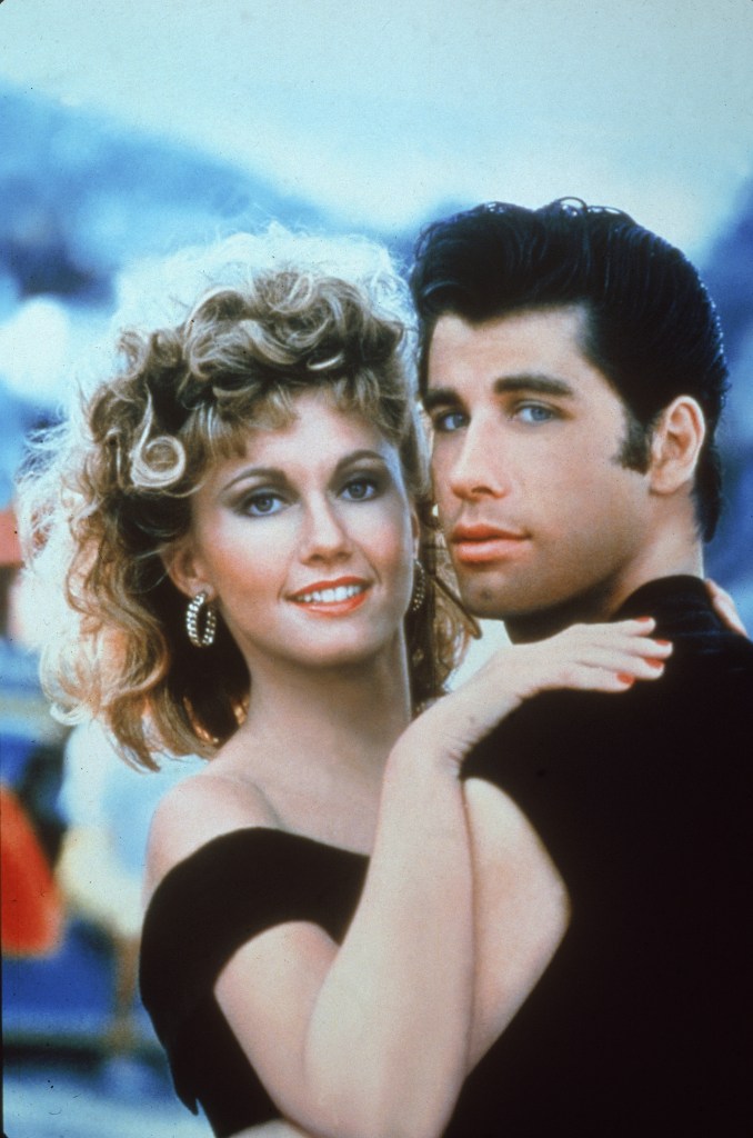 Actors John Travolta and Olivia Newton-John embrace in a promotional still for the film, 'Grease,' directed by Randal Kleiser, 1978. 