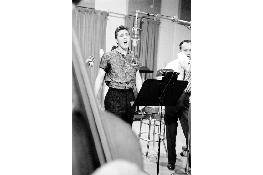 Singer Elvis Presley (L) recording song in studio