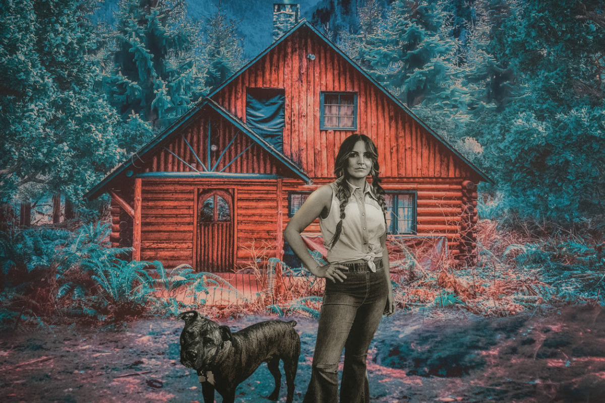 Brit Taylor poses outside cabin