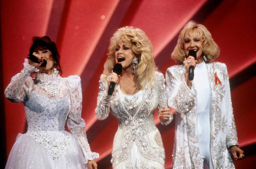 Photo of Tammy Wynette, Loretta Lynn and Dolly Parton performing together, circa 1980.