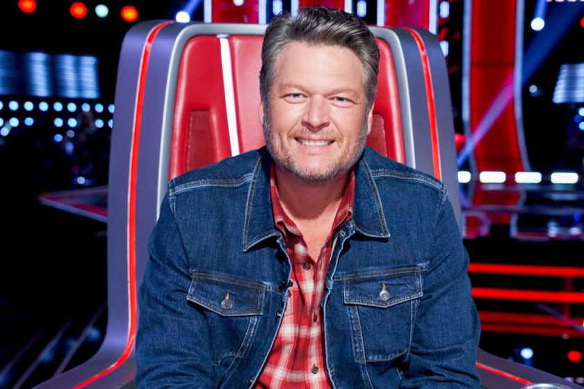 Blake Shelton poses in his chair as a coach on The Voice season 22