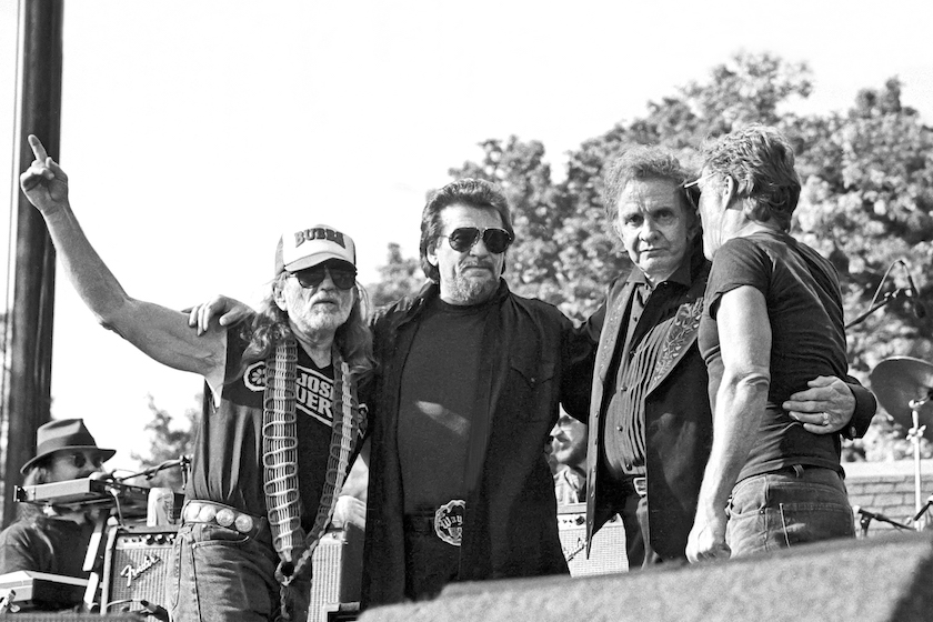 Country music supergroup The Highwaymen with, l-r, Willie Nelson (wearing a 'Bubba' cap in support of President Bill Clinton), Waylon Jennings, Johnny Cash, and Kris Kristofferson, take a bow at Central Park SummerStage, New York