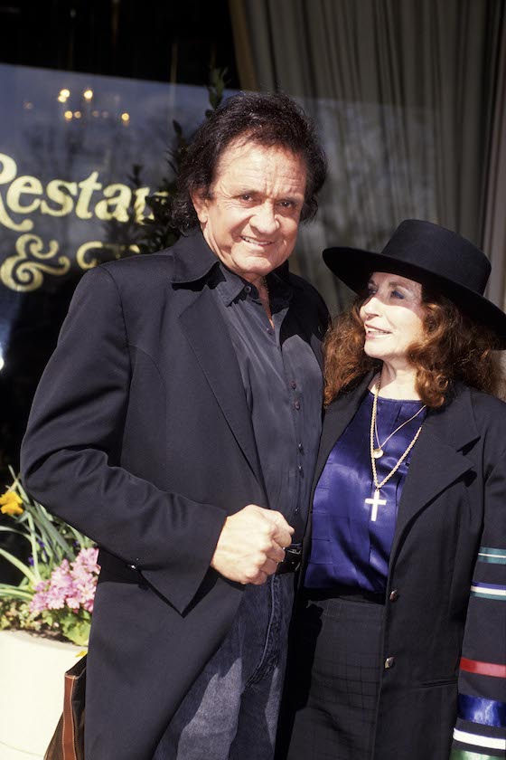 UNSPECIFIED - JANUARY 01: Photo of Johnny CASH and June CARTER; Portrait of Johnny Cash with wife June Carter Cash outside a restaurant 