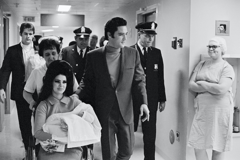 (Original Caption) 2/7/1968-Memphis, TN: Evis Presley with his wife and daughter as they leave Baptist Hospital.
