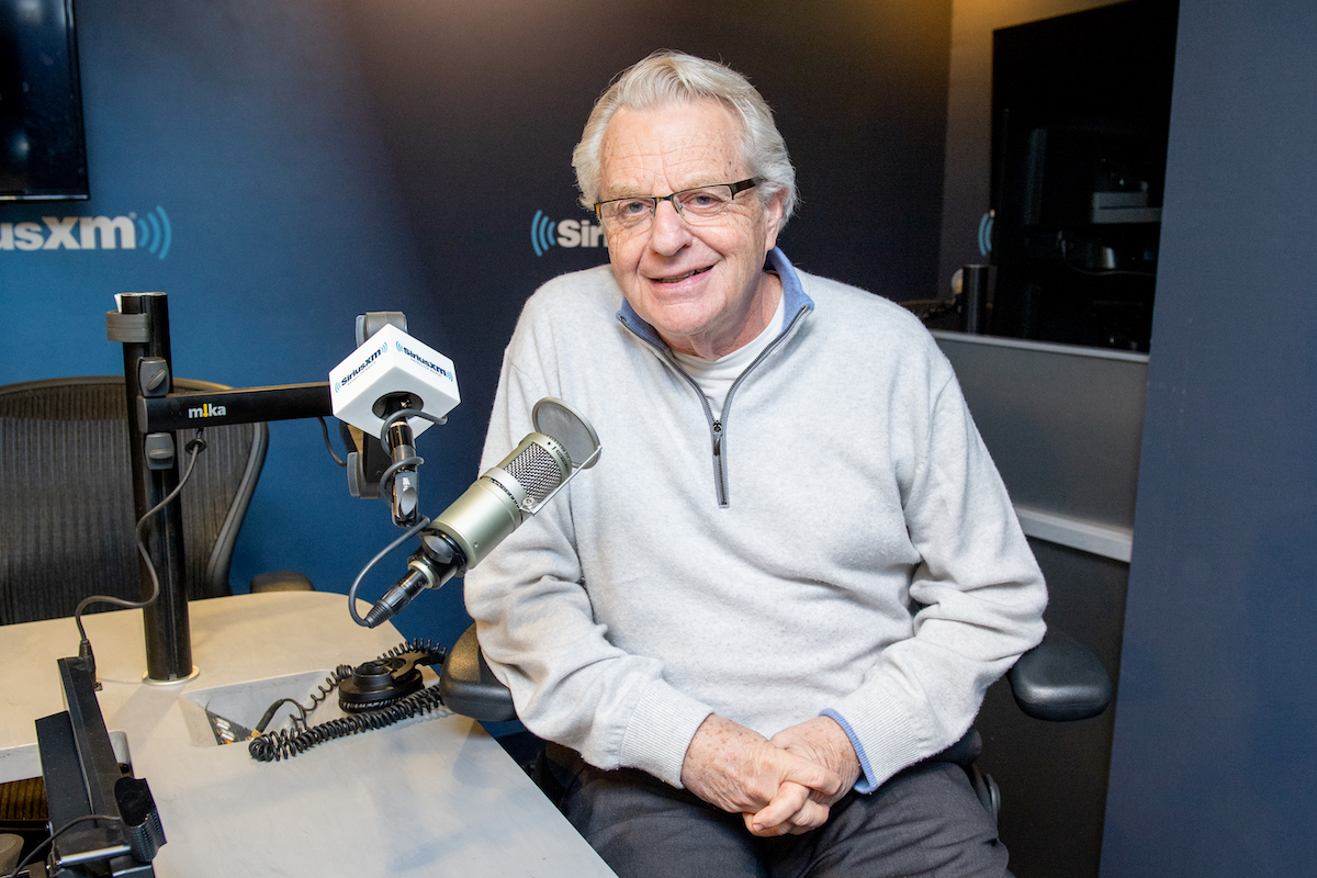 Ex-mayor/news anchorman/talk show host Jerry Springer (C) chatting w. co-anchor Jim Watkins (L) & a technician before news broadcast at WLWT-TV.